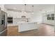 Modern kitchen with an island, stainless steel appliances, and light hardwood floors at 14035 Kelly Park Ct, Parrish, FL 34219