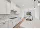 Clean, modern kitchen with quartz countertops, white cabinets, and stainless steel appliances at 14035 Kelly Park Ct, Parrish, FL 34219
