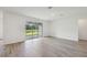 Spacious living area with a large window, light hardwood flooring, and bright lighting at 14035 Kelly Park Ct, Parrish, FL 34219