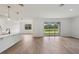 Open-concept living area with light hardwood flooring, and a view of the yard at 14035 Kelly Park Ct, Parrish, FL 34219
