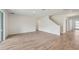 Spacious living area with light hardwood flooring, white walls, and bright lighting at 14035 Kelly Park Ct, Parrish, FL 34219