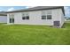 Backyard featuring well-maintained lawn and exterior view of the modern home at 7736 Gilchrist Springs Dr, Parrish, FL 34219