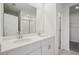 Modern bathroom with double sinks, white cabinets, and a glass-enclosed shower at 7736 Gilchrist Springs Dr, Parrish, FL 34219
