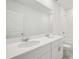Bright bathroom featuring double sinks, white cabinets, and a full shower with tiled walls at 7736 Gilchrist Springs Dr, Parrish, FL 34219