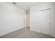 Spacious bedroom featuring soft carpet, ample closet space, and a clean, minimalist aesthetic at 7736 Gilchrist Springs Dr, Parrish, FL 34219