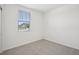 Bright and airy bedroom with a cozy carpet and a window overlooking the neighborhood at 7736 Gilchrist Springs Dr, Parrish, FL 34219