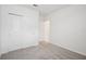 Spacious bedroom featuring soft carpet, ample closet space, and a clean, minimalist aesthetic at 7736 Gilchrist Springs Dr, Parrish, FL 34219