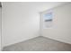 Bright bedroom with soft carpet, minimalist decor, and a window for natural light at 7736 Gilchrist Springs Dr, Parrish, FL 34219