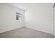 Bright bedroom with soft carpet, minimalist decor, and a window for natural light at 7736 Gilchrist Springs Dr, Parrish, FL 34219