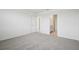 Bedroom featuring neutral carpet and ensuite bathroom access at 7736 Gilchrist Springs Dr, Parrish, FL 34219