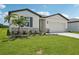 Charming single-story home with a well-manicured lawn and inviting front entrance at 7736 Gilchrist Springs Dr, Parrish, FL 34219