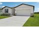 Charming single-Gathering home with a two-car garage, manicured lawn, and stone veneer accents at 7736 Gilchrist Springs Dr, Parrish, FL 34219