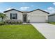 Charming single-story home with a well-manicured lawn and inviting front entrance at 7736 Gilchrist Springs Dr, Parrish, FL 34219