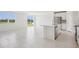 Open-concept kitchen and living area with island, bright light, and backyard views at 7736 Gilchrist Springs Dr, Parrish, FL 34219