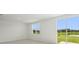 Bright living space with a large window and sliding glass doors overlooking a scenic backyard at 7736 Gilchrist Springs Dr, Parrish, FL 34219
