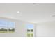 Bright living room with large windows offering scenic views and ample natural light at 7736 Gilchrist Springs Dr, Parrish, FL 34219