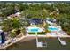 Stunning aerial view of waterfront home featuring multiple pools, lush landscaping, and private dock at 8390 40Th N Ave, St Petersburg, FL 33709