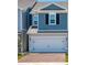 Charming two-story home featuring a two-car garage, blue siding, and classic black shutters at 42854 Park View Dr Way, Punta Gorda, FL 33982