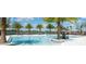 Resort-style pool with plenty of seating and swaying palm trees overlooking the water at 42854 Park View Dr Way, Punta Gorda, FL 33982