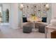 A cozy sitting area boasts modern decor, stylish accent seating, decorative art, and carpeted floors at 17378 Alderwood Ln, Punta Gorda, FL 33982