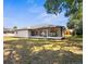 A screened porch overlooks a spacious backyard with lush greenery, perfect for outdoor relaxation and entertainment at 4284 Persian Ln, North Port, FL 34287