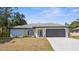 Charming single-story home with a gray roof, spacious driveway, and well-maintained front yard at 4284 Persian Ln, North Port, FL 34287