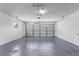 Clean garage featuring painted walls, sealed floors, and an automated overhead door at 4284 Persian Ln, North Port, FL 34287