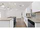 Modern kitchen features a center island with a stovetop and updated stainless steel appliances at 4284 Persian Ln, North Port, FL 34287