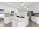 Modern kitchen boasts stainless appliances, white cabinets, marble countertops and center island at 4284 Persian Ln, North Port, FL 34287