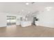 Bright living room featuring wood-look floors, an island, updated lighting, and an open-concept design at 4284 Persian Ln, North Port, FL 34287