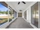 Enclosed patio with sliding glass doors, screened openings, and outdoor ceiling fan at 4284 Persian Ln, North Port, FL 34287