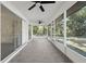 Enclosed patio featuring screened windows, tiled floors, and outdoor ceiling fans at 4284 Persian Ln, North Port, FL 34287