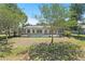 Spacious backyard with screened pool offers a serene setting, blending indoor-outdoor living and lush landscaping at 6731 Northlake Dr, Zephyrhills, FL 33542
