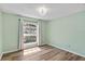 Bedroom with hardwood floors, large window and light green paint on the walls at 6731 Northlake Dr, Zephyrhills, FL 33542