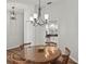 Elegant dining room with wood floors and a stylish chandelier, adjacent to an updated kitchen, perfect for entertaining at 6731 Northlake Dr, Zephyrhills, FL 33542