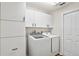 Laundry room featuring a washer, dryer, white cabinets and white walls at 6731 Northlake Dr, Zephyrhills, FL 33542