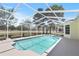 Screened-in pool with a beautiful view of the golf course, perfect for outdoor relaxation and recreation at 6731 Northlake Dr, Zephyrhills, FL 33542