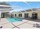 Large pool with screened enclosure and covered lanai with table and chairs at 6731 Northlake Dr, Zephyrhills, FL 33542