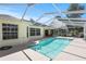Inviting screened-in pool features a modern design, creating a private outdoor oasis for leisure and entertainment at 6731 Northlake Dr, Zephyrhills, FL 33542