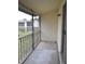 Balcony with concrete floor and screening overlooking the lawn at 8440 Old Post Rd # 202, Port Richey, FL 34668
