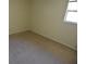 Simple bedroom with wall-to-wall carpet and neutral paint at 8440 Old Post Rd # 202, Port Richey, FL 34668