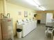 Community laundry room with rows of washers and propane water heater at 8440 Old Post Rd # 202, Port Richey, FL 34668