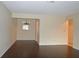 Spacious open living room with dark flooring and connections to other rooms at 8440 Old Post Rd # 202, Port Richey, FL 34668