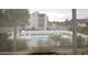 View from the balcony of the community pool surrounded by a white fence at 8440 Old Post Rd # 202, Port Richey, FL 34668