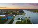 Waterfront home features lush landscaping, metal roof, and canal access at 9277 St Paul Dr, Port Charlotte, FL 33981