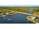 Aerial view features a waterfront home with a private dock, set along a canal near a bridge at 9277 St Paul Dr, Port Charlotte, FL 33981