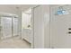 Well-lit bathroom featuring a tiled shower with glass door and a vanity with a sink at 9277 St Paul Dr, Port Charlotte, FL 33981