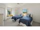 Charming bedroom with two twin beds, bright windows, and neutral carpeting at 9277 St Paul Dr, Port Charlotte, FL 33981