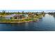 Waterfront home features a private dock, screened lanai, lush lawn, and mature palms with stunning views at 9277 St Paul Dr, Port Charlotte, FL 33981