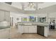 Bright kitchen overlooks waterfront with breakfast bar and stainless dishwasher at 9277 St Paul Dr, Port Charlotte, FL 33981